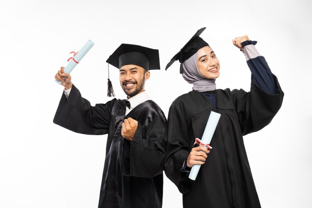 female,and,male,graduate,students,wearing,togas,with,clenched,hands