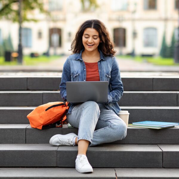 joyful,young,indian,woman,student,studying,online,,using,laptop,computer